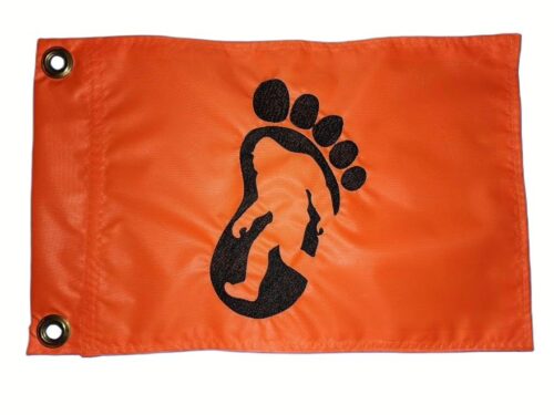 Bigfoot footprint safety flag with embroidered black paw print track and silhouette on bright orange nylon rectangle with brass grommets