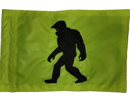 Motocross Bigfoot safety flag with embroidered black Sasquatch wearing dirt bike helmet on lime squeeze nylon rectangle with whip sleeve