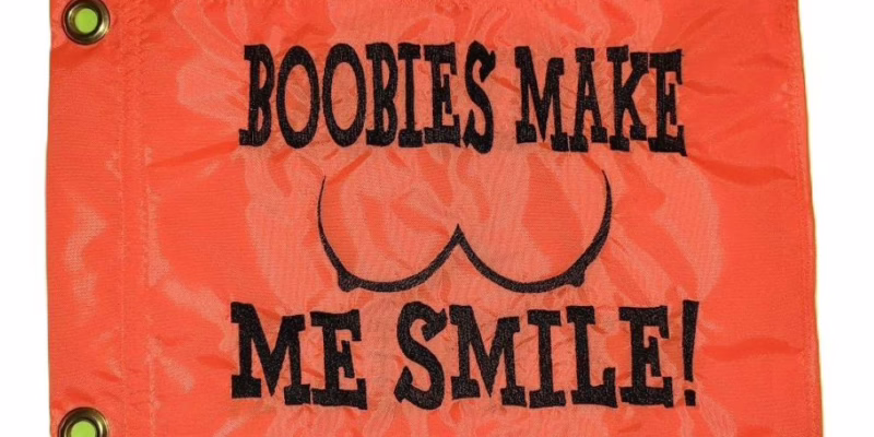 Boobies Make Me Smile safety flag with embroidered outline and text on safety orange nylon rectangle with brass grommets