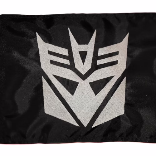 Transformers Decepticon safety flag with dense embroidered silver faction crest on black nylon rectangle with solid brass grommets