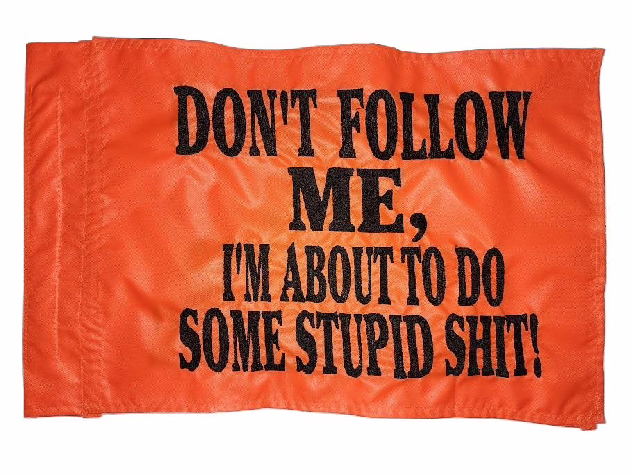 Don't follow me safety flag with dense embroidered black text on orange nylon rectangle with whip sleeve