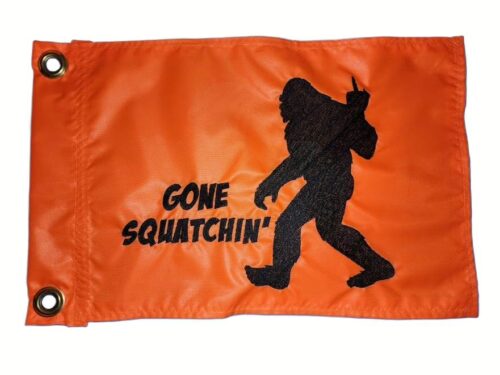 Gone Squatchin safety flag with embroidered black Bigfoot flipping middle finger on bright orange nylon rectangle with brass grommets