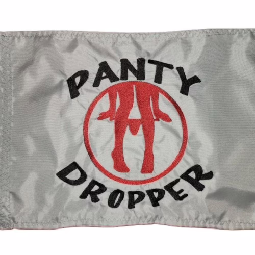 Panty dropper safety flag with dense embroidered black text and red silhouette logo on silver nylon rectangle with whip sleeve