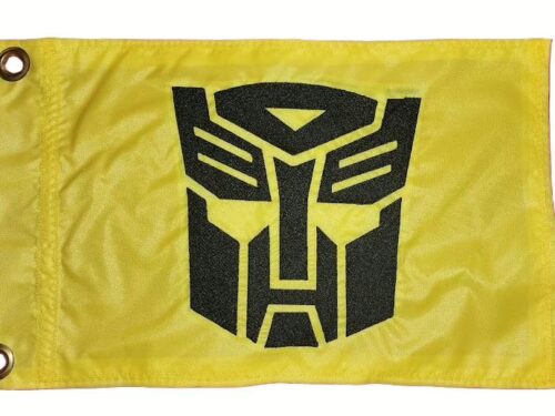 Transformers Autobot safety flag with dense embroidered black faction crest on yellow nylon rectangle with solid brass grommets