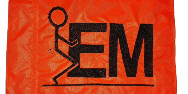 Fuck em safety flag with dense embroidered black stick figure graphic and text on orange nylon rectangle with whip sleeve
