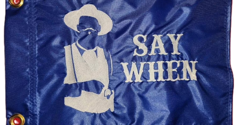 Doc Holliday Say When safety flag with dense embroidered gunslinger silhouette and western text on nylon rectangle with brass grommets