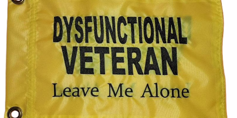 Dysfunctional Veteran Leave Me Alone safety flag with embroidered black lettering on bright yellow nylon rectangle with brass grommets