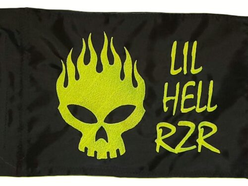 Lil Hell Rzr safety flag with dense embroidered chartreuse flaming skull graphic and custom text on black nylon rectangle with whip sleeve