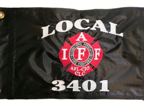 IAFF Local 3401 firefighter safety flag with dense embroidered red and white union Maltese cross logo and text on black nylon rectangle with solid brass grommets