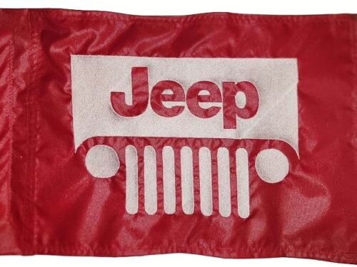 Jeep safety flag with embroidered white seven-slot grille and logo on red nylon rectangle with whip sleeve