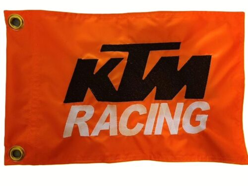 KTM Racing safety flag with embroidered black KTM logo and white Racing text on safety orange nylon rectangle with brass grommets