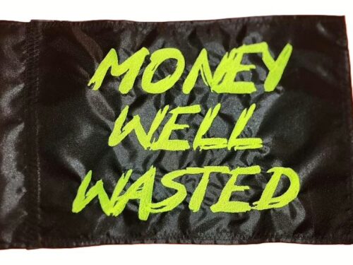 Money Well Wasted safety flag with embroidered neon green brush lettering on black nylon rectangle with whip sleeve