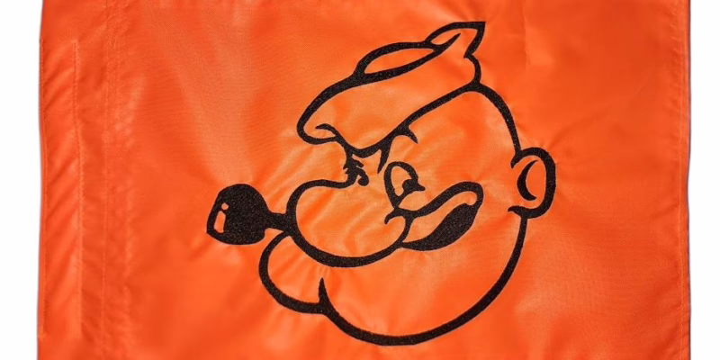 Popeye the Sailor Man safety flag with dense embroidered sailor head and corncob pipe outline on nylon rectangle with whip sleeve