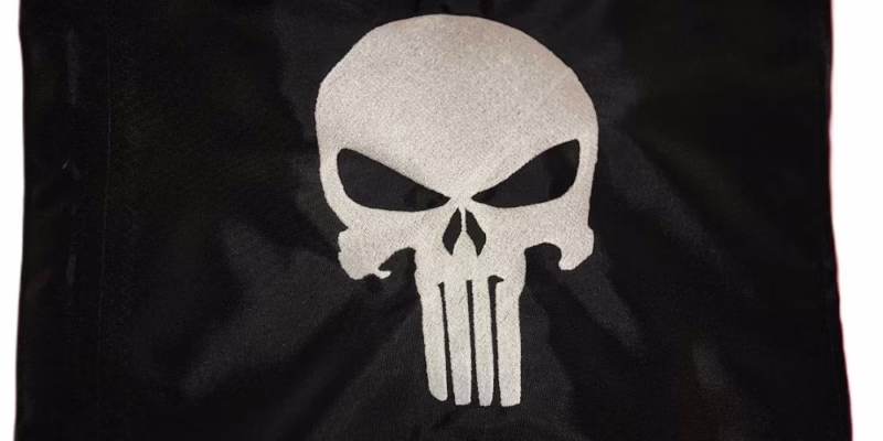 Punisher skull safety flag with dense embroidered white vigilante skull graphic on black nylon rectangle with whip sleeve