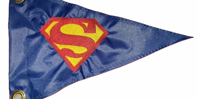 Superhero shield emblem safety flag with dense embroidered diamond S logo on nylon pennant with brass grommets
