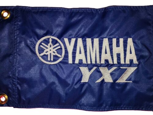 Yamaha YXZ safety flag with embroidered silver tuning forks and YXZ lettering on royal blue nylon rectangle with brass grommets