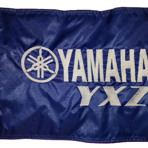 Yamaha YXZ safety flag with embroidered silver tuning forks and YXZ lettering on royal blue nylon rectangle with brass grommets