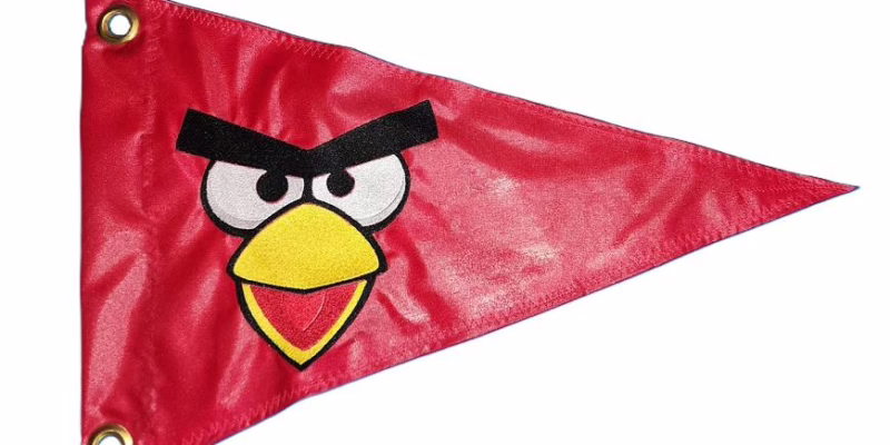 Angry Bird Red face safety flag with dense embroidered unibrow eyes and beak on nylon pennant with brass grommets