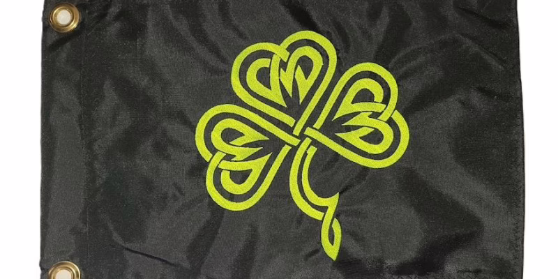 Celtic shamrock safety flag with dense embroidered lime squeeze green Celtic knot clover on black nylon rectangle with solid brass grommets