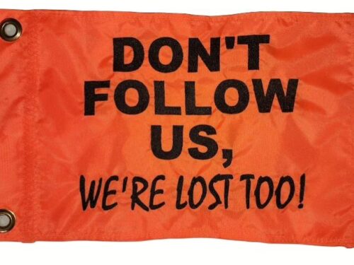 Don't follow us were lost too safety flag made by Devil Woman Flags with dense embroidered black text graphic on high-visibility orange nylon rectangle with solid brass grommets