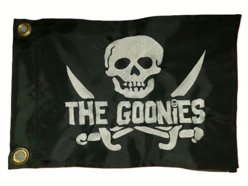 Black rectangle safety flag featuring embroidered white skull and crossed cutlass swords with THE GOONIES block lettering and two heavy-duty brass mounting grommets