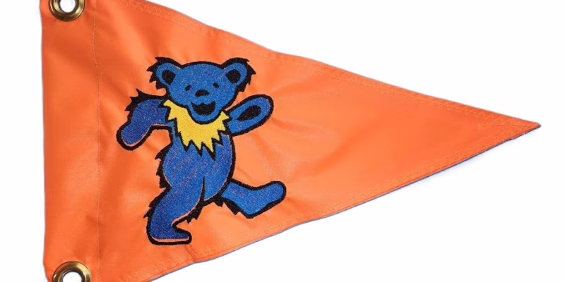 Grateful Dead dancing bear safety flag with embroidered solid blue dancing bear on safety orange nylon pennant with brass grommets