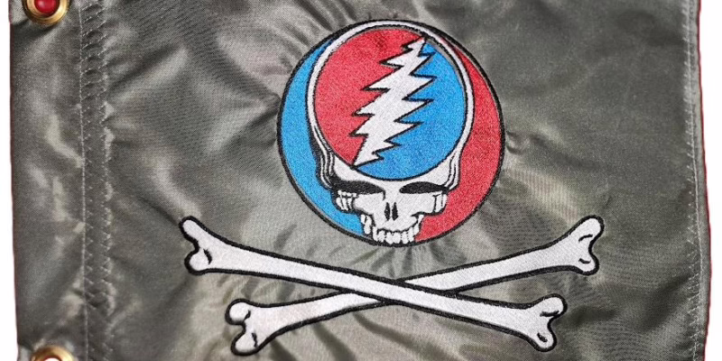 Grateful Dead skull and crossbones safety flag with embroidered red and blue Steal Your Face skull over crossed bones on titanium gray nylon rectangle with brass grommets