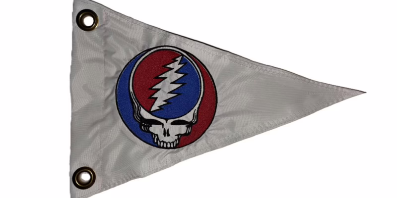 Steal Your Face safety flag with red and blue embroidered lightning bolt skull on white nylon pennant with brass grommets