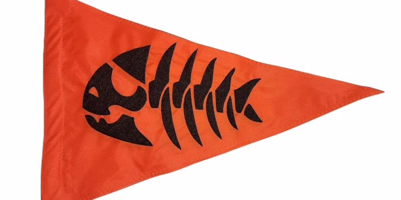 Fishbone safety flag with black embroidered fish skeleton on blaze orange nylon pennant with whip sleeve