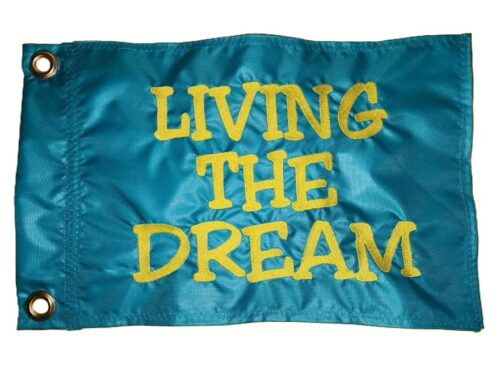 Living The Dream safety flag with yellow embroidered text on teal nylon rectangle