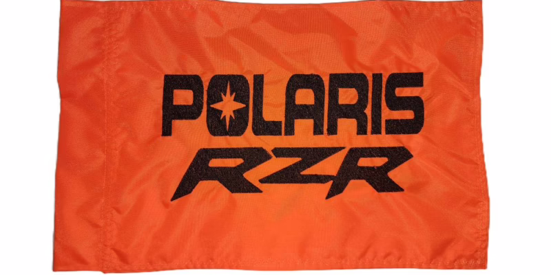 Polaris RZR safety flag with embroidered black stacked block lettering on safety orange nylon rectangle with whip sleeve
