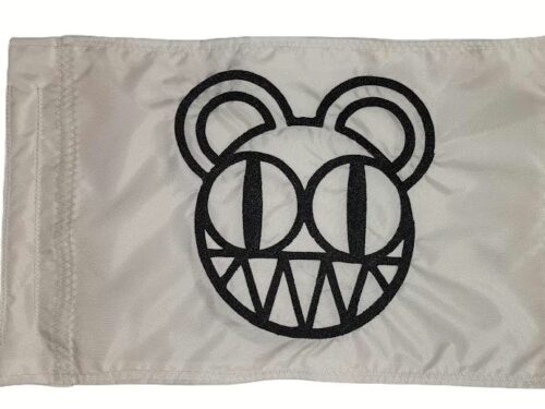 Radiohead Modified Bear safety flag with dense embroidered grinning bear emblem on nylon rectangle with whip sleeve