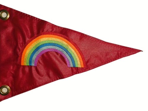 Rainbow safety flag with dense embroidered multi-color rainbow arch on red nylon pennant with solid brass grommets