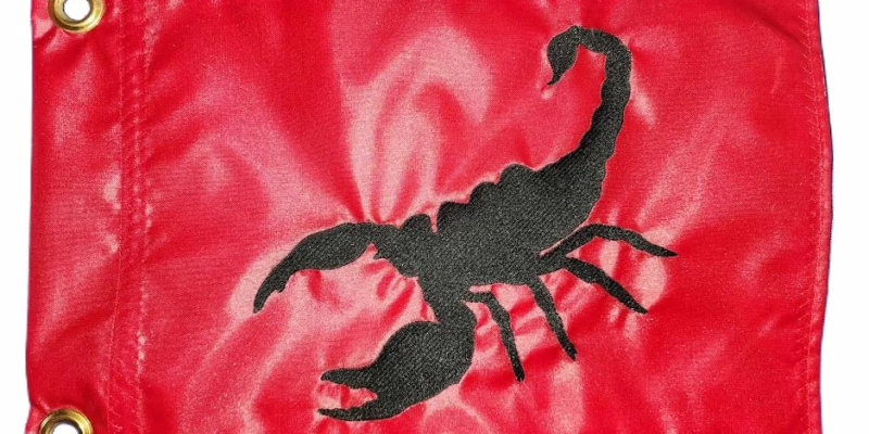 Scorpion safety flag with dense embroidered black scorpion silhouette on vibrant red nylon rectangle with solid brass grommets
