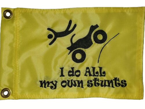 I Do All My Own Stunts ATV safety flag with embroidered flying rider and launching quad on safety yellow nylon rectangle with brass grommets