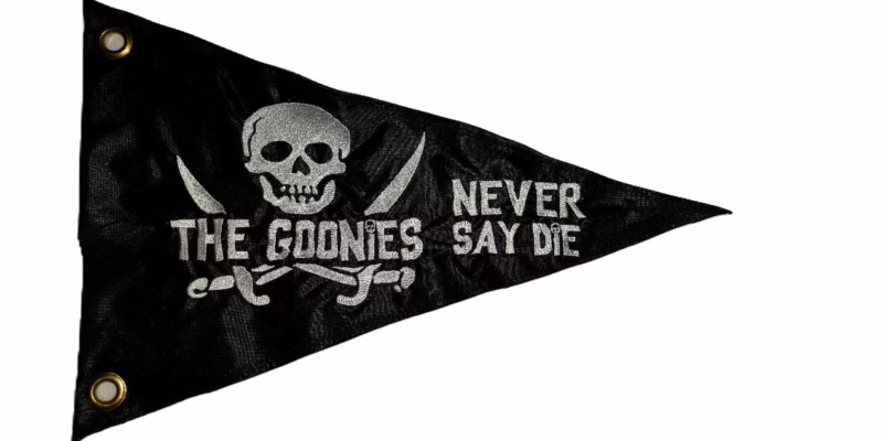 Goonies Never Say Die safety flag with white embroidered skull and crossed swords on black nylon pennant