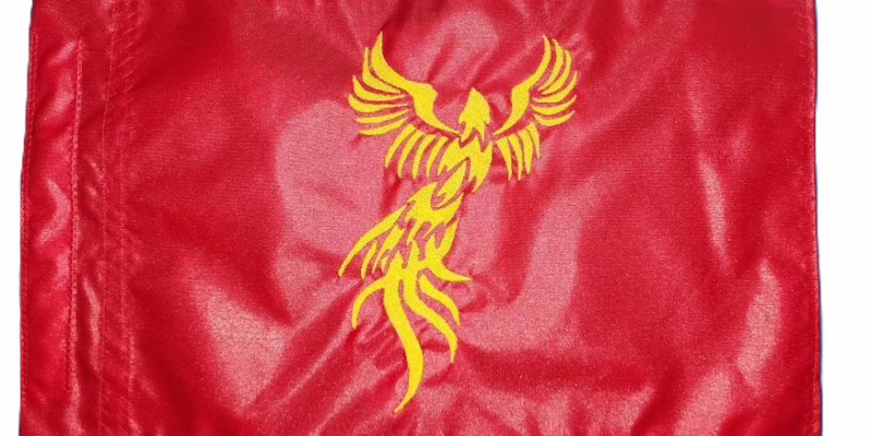 Tribal Phoenix safety flag with dense embroidered rising firebird silhouette on nylon rectangle with whip sleeve