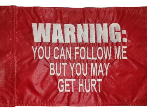 Warning you can follow me but you may get hurt safety flag made by Devil Woman Flags with dense embroidered white text graphic on red nylon rectangle with whip sleeve