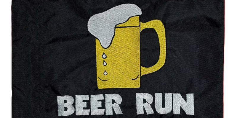 Beer Run safety flag with dense embroidered yellow beer mug and white text on black nylon rectangle with whip sleeve