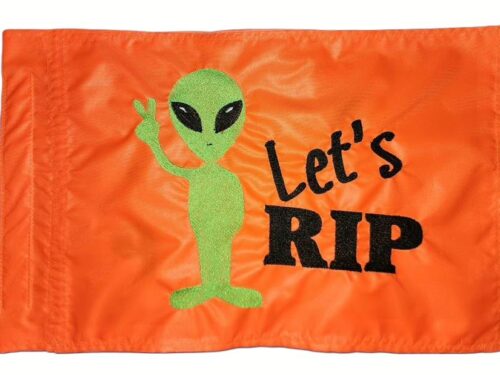 Alien Lets Rip safety flag with fluorescent green embroidered alien peace sign and black Lets Rip text on orange nylon rectangle with whip sleeve