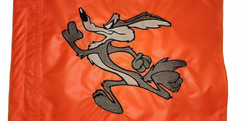 Wile E. Coyote running safety flag with dense embroidered full body cartoon character on nylon rectangle with whip sleeve