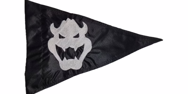 Bowser safety flag with silver embroidered Bowser skull face emblem on black nylon pennant with whip sleeve
