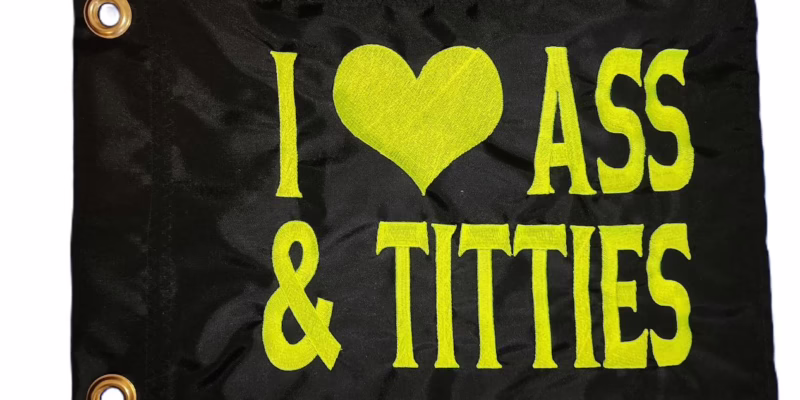 I Heart Ass and Titties safety flag with lime squeeze green embroidered heart and block lettering on black nylon rectangle