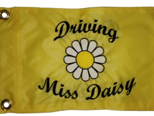 Driving Miss Daisy safety flag with dense embroidered daisy graphic and black text on yellow nylon rectangle with solid brass grommets