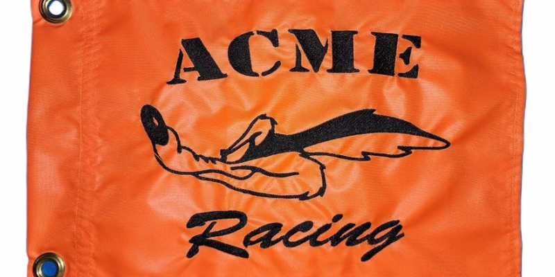 Acme Racing Wile E Coyote safety flag with dense embroidered sprinting coyote and typography on nylon rectangle with brass grommets