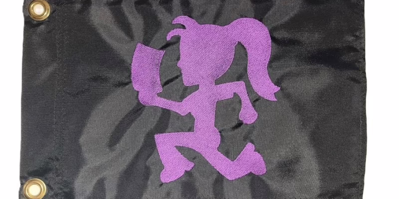 Hatchet girl safety flag with dense embroidered running ponytail silhouette on nylon rectangle with brass grommets