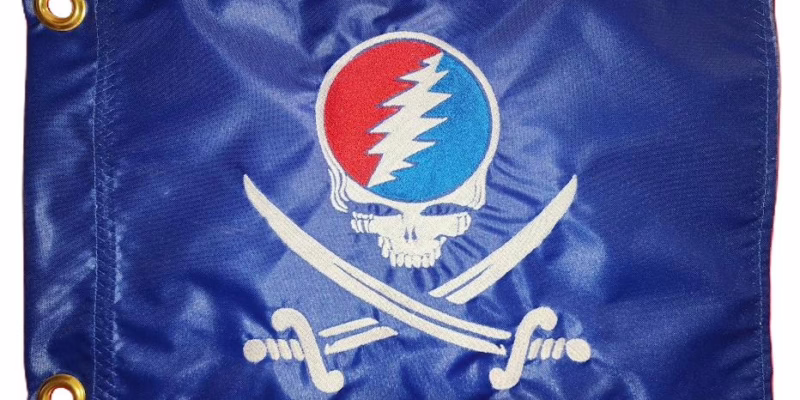 Steal Your Face Pirate safety flag with red and blue embroidered lightning bolt skull and crossed swords on royal blue nylon rectangle with brass grommets