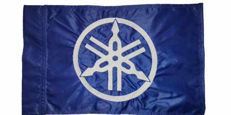 Yamaha safety flag with embroidered white tuning forks emblem on royal blue nylon rectangle with whip sleeve