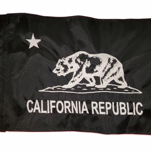 California Republic safety flag with dense embroidered white grizzly bear, star, and text on black nylon rectangle with solid brass grommets
