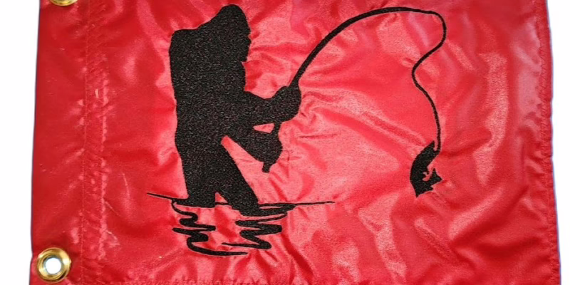Bigfoot fishing safety flag with embroidered black Sasquatch reeling in fish on red nylon rectangle with brass grommets